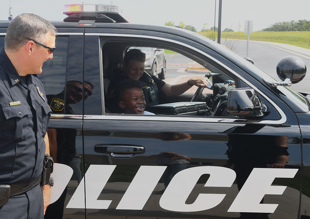 Ashton Dixon rides in a police car